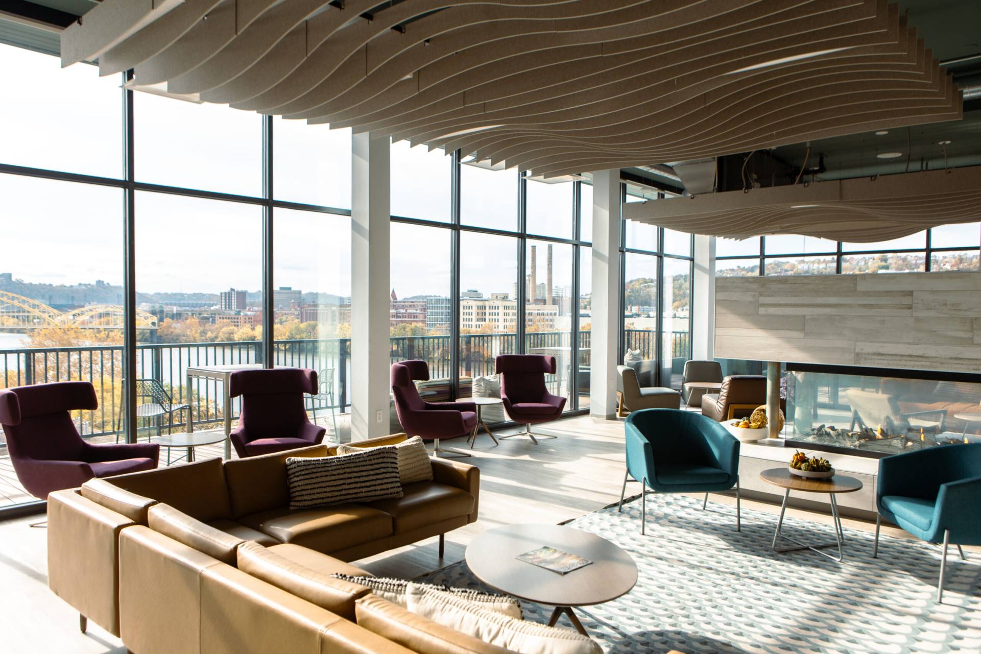 Club room featuring fireplace, couches, and view of downtown Pittsburgh